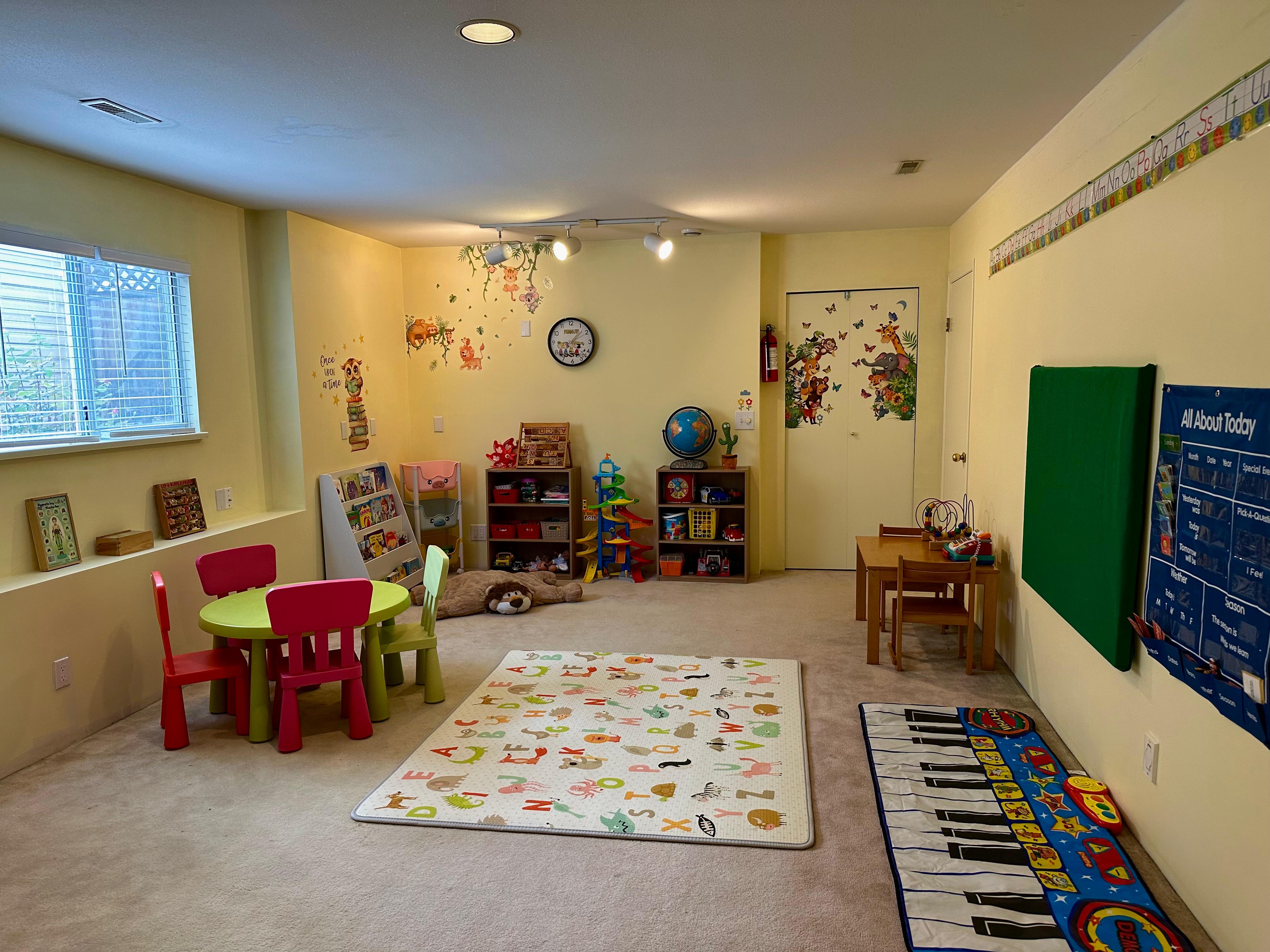 Main daycare play area with child-sized tables, rugs, and learning spaces