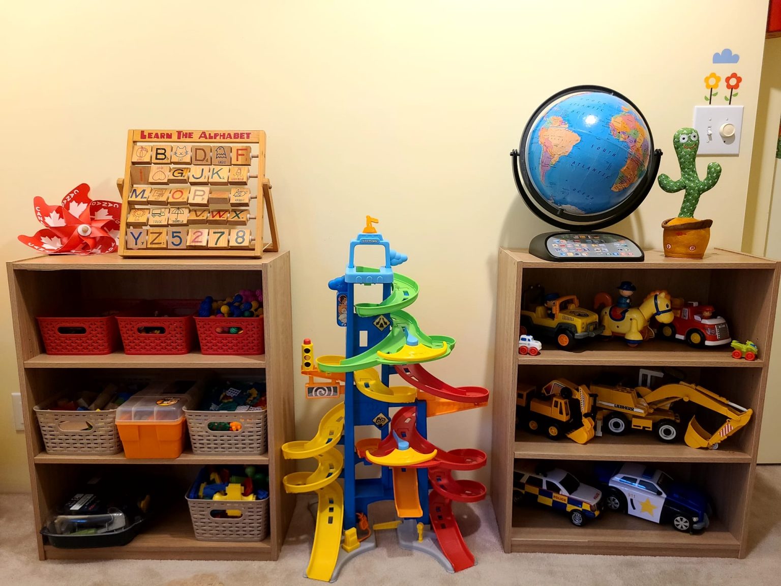 Daycare toy shelves with learning toys, vehicles, and a globe