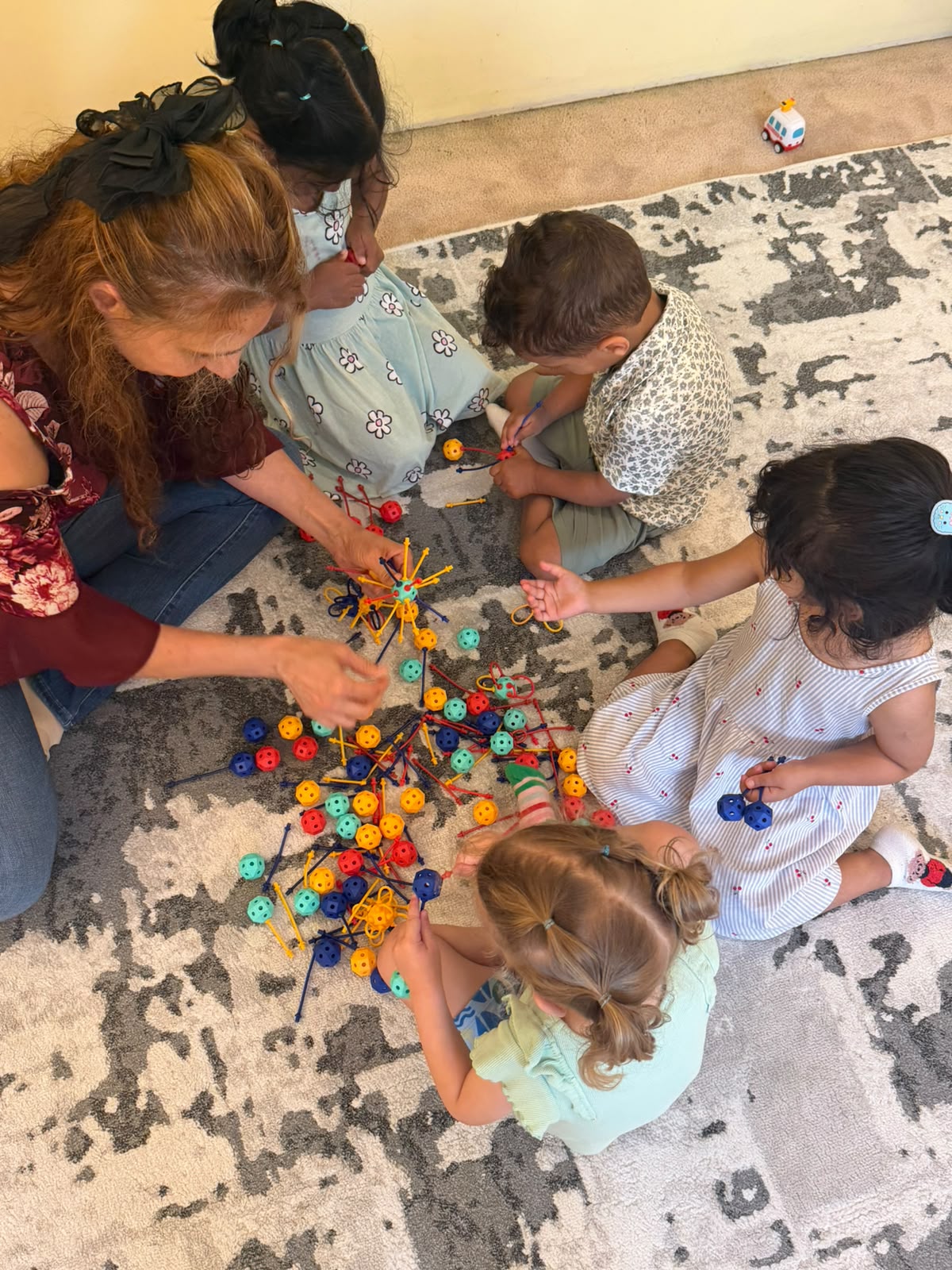 Children building with colorful connecting toys together