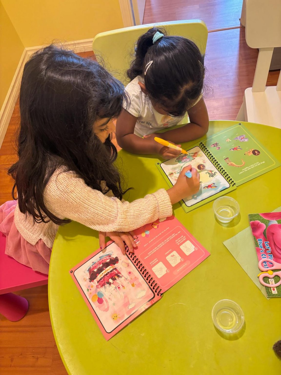 Children drawing together at a child-sized table