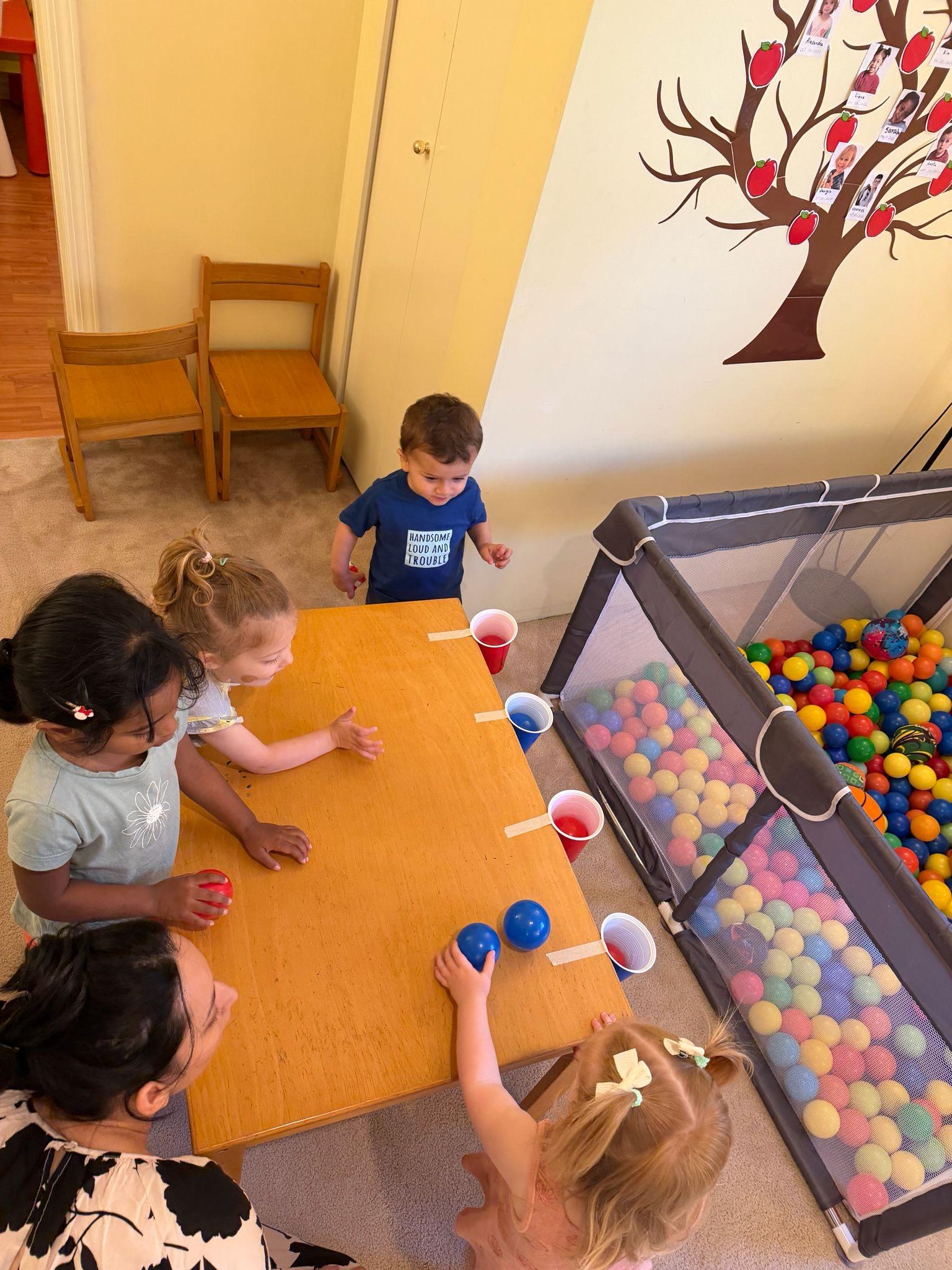 Children playing an indoor ball activity at daycare