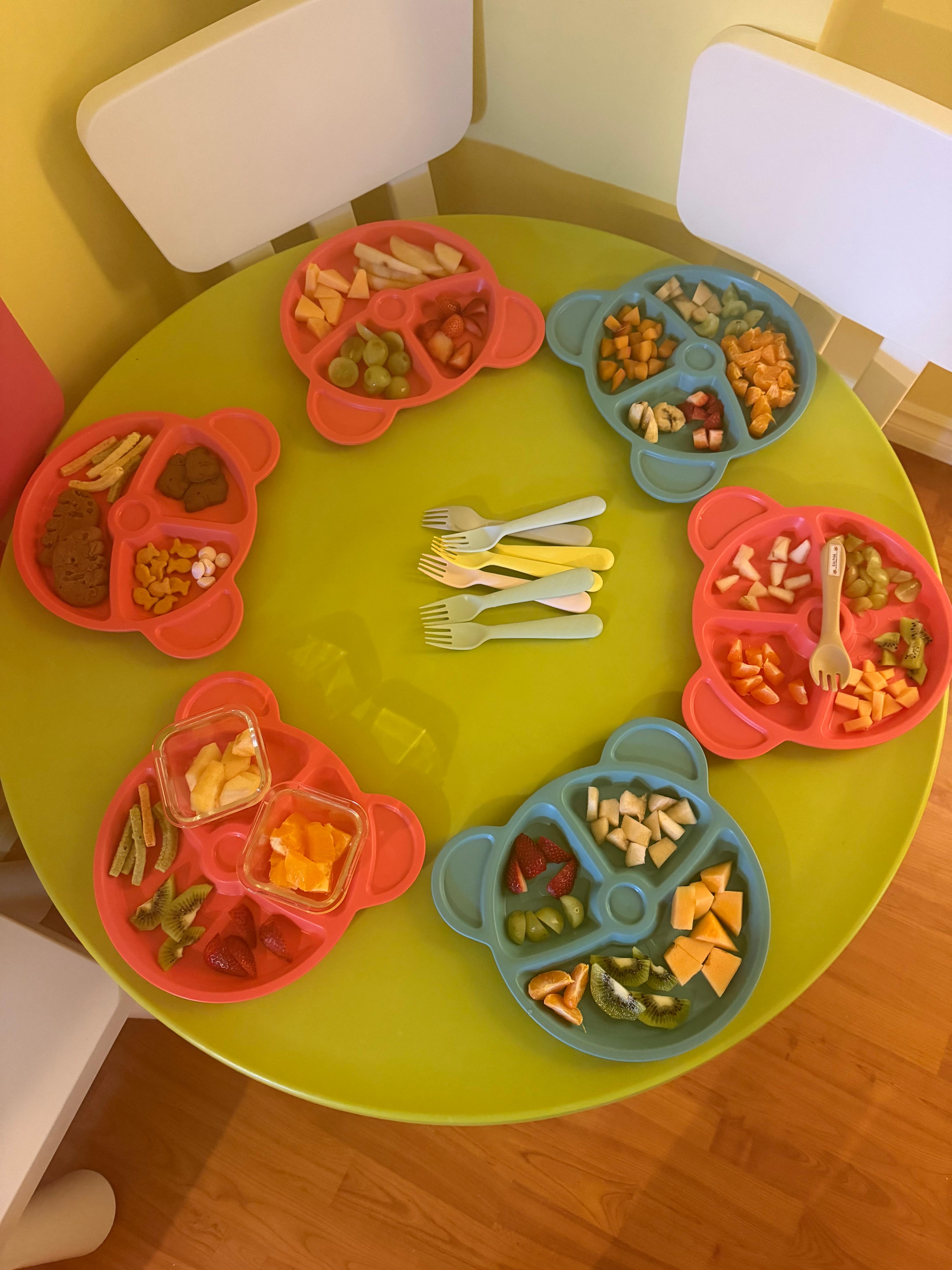 Prepared daycare snack plates on a child-sized table