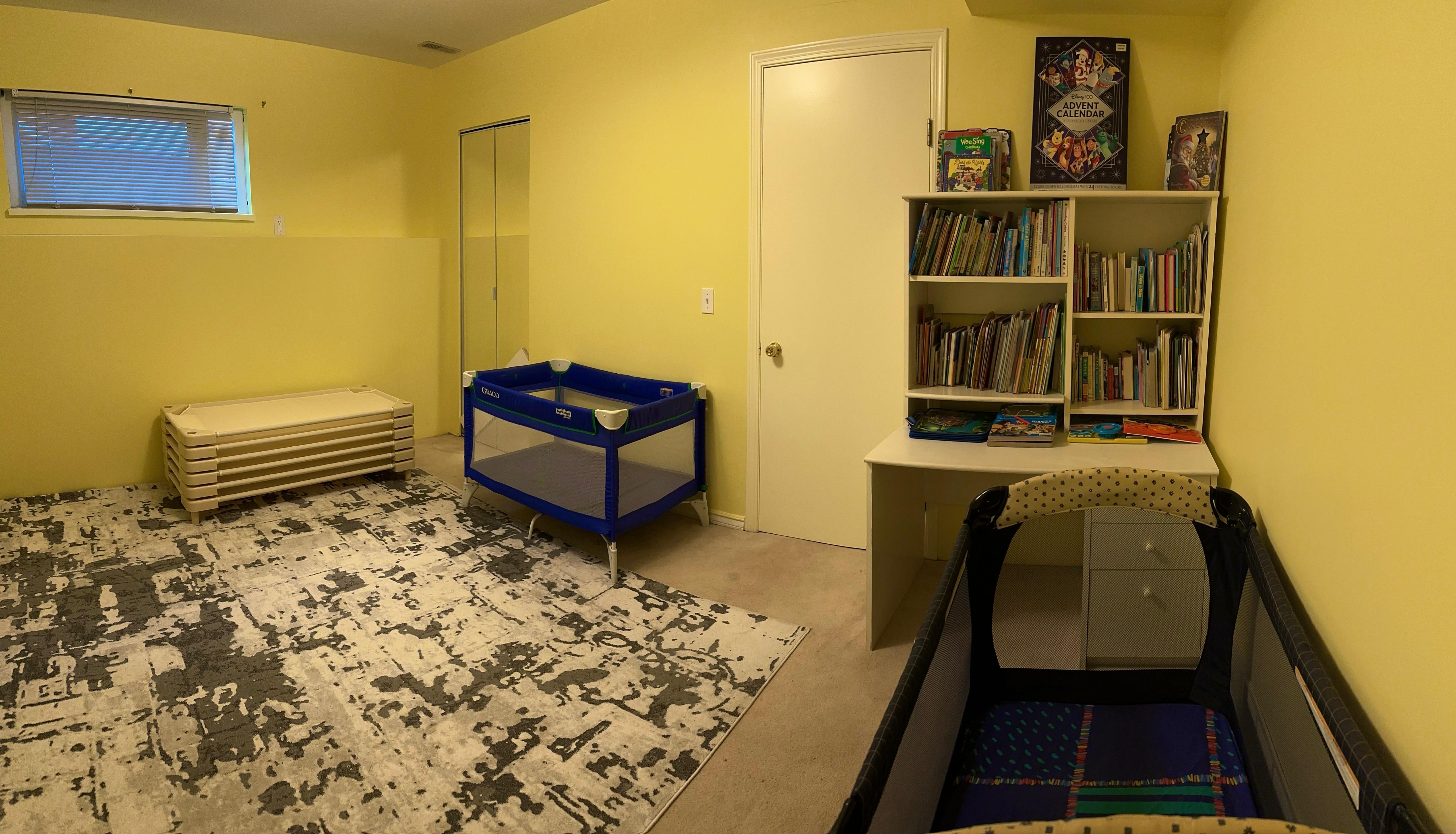 Quiet rest and book area with cots, bookshelves, and soft rugs